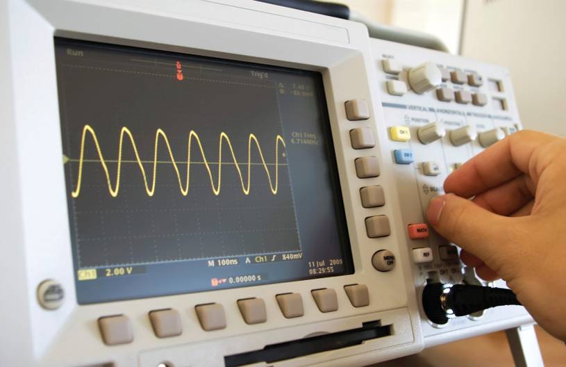 An oscilloscope and sine wave display